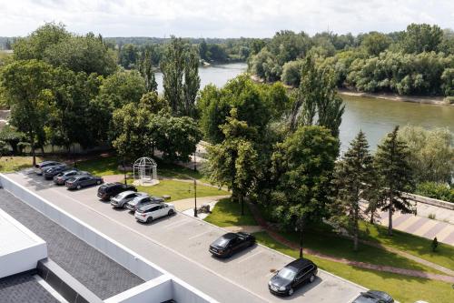 a line of cars parked on a road next to a river at Park Hotel in Tiraspol