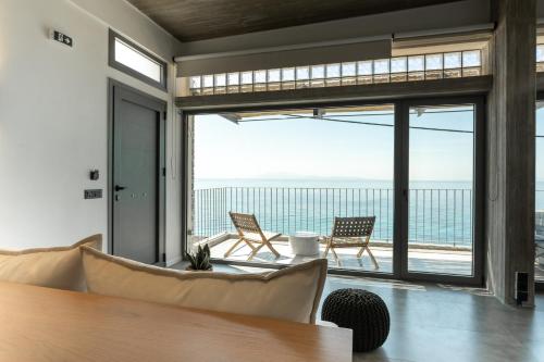 a living room with a view of the ocean at Above Blue Villas in Plomarion