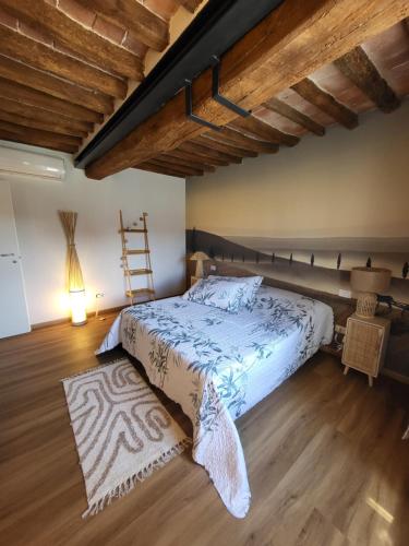 a bedroom with a bed and a wooden floor at CasAlbina in Mezzana