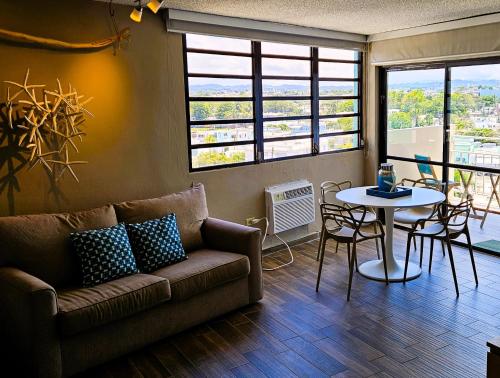 a living room with a couch and a table at Oceanview Beach Block BALCONY Ocean and City View in San Juan