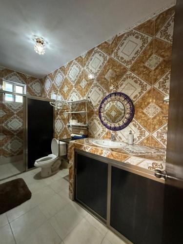 a bathroom with a sink and a toilet at Hacienda Cúpulas Blue Private Residence Club in Cozumel