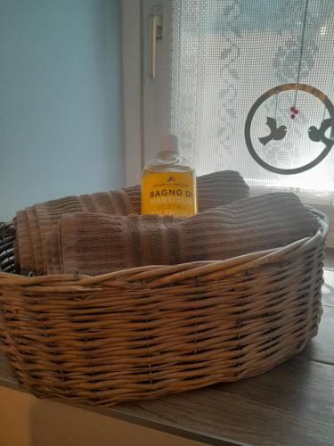 a basket with a bottle of laundry detergent in it at L'Incanto dell'Airone in Malgrate