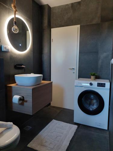 a bathroom with a washing machine and a sink at Apartment Paola - Šibenik in Šibenik