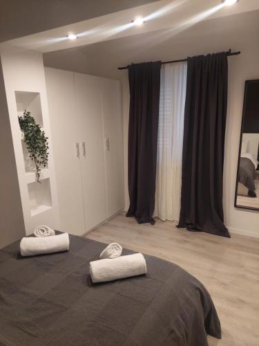 a bedroom with a bed with two towels on it at Apartment Paola - Šibenik in Šibenik