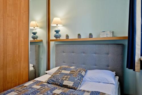 Ένα ή περισσότερα κρεβάτια σε δωμάτιο στο BlueApart Apartamenty Jurata