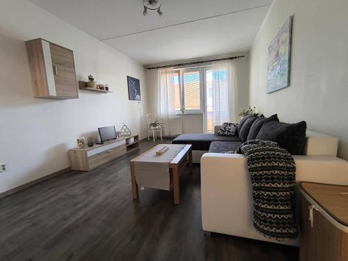 a living room with a couch and a table at Vzdušný byt v centru Hluboké nad Vltavou in Hluboká nad Vltavou
