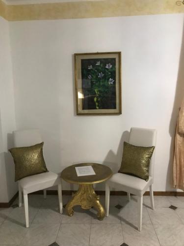 a table and two chairs and a table and a picture at Massenzio's house in Lecco