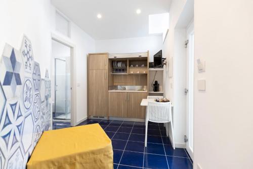 a room with a blue tiled floor and a table at VENART by AnrealeRooms in Paestum