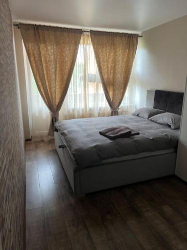 a bedroom with a bed and a window with curtains at 2 Bedroom flat for rent in Daugavpils