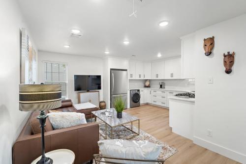 a kitchen and living room with a couch and a table at The King's Retreat I in Houston