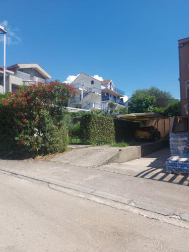 an empty street with houses in the background at Barcelona Apartments in Tivat