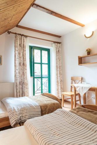 a bedroom with two beds and a window at Zielony koń in Sorkwity