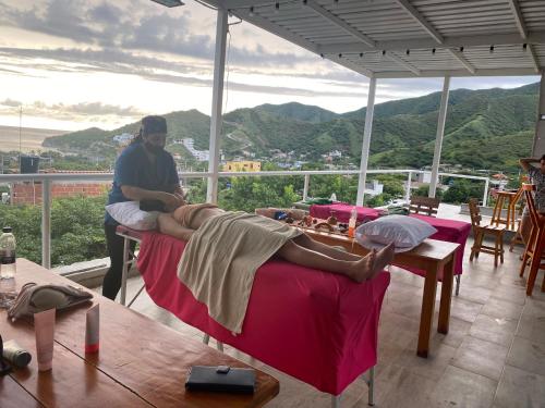 a man sitting on a couch with his feet on a table at Vito Hotel Boutique in Taganga