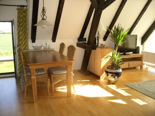 a dining room with a table and chairs and a tv at Haus Schaumburger Land in Volksdorf