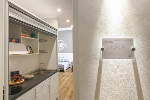 a kitchen with a refrigerator with a pizza sign on it at Camere Amely in Sanremo