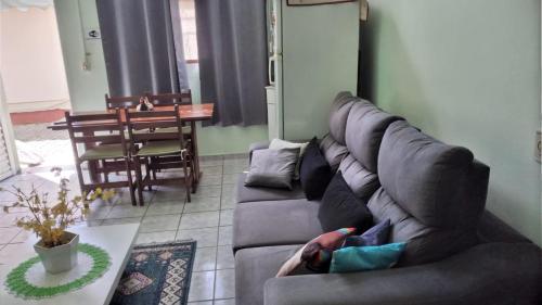 a person laying on a couch in a living room at POUSADA SERRANO in São Bento do Sapucaí
