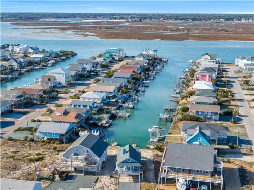 an aerial view of a harbor with houses and boats at On Island Time in Topsail Beach