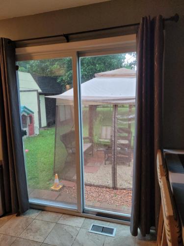 a sliding glass door with a view of a backyard at Cozy 6 bedroom home with Gameroom and Fire pit. in Rawsonville
