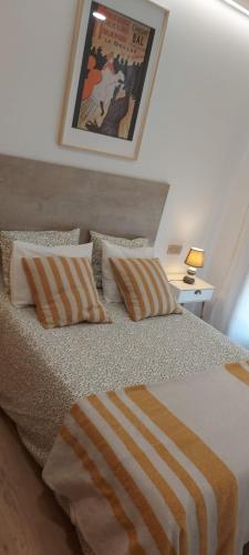 a bedroom with a bed with two pillows at Casa en piedra (Stone House) in Porriño