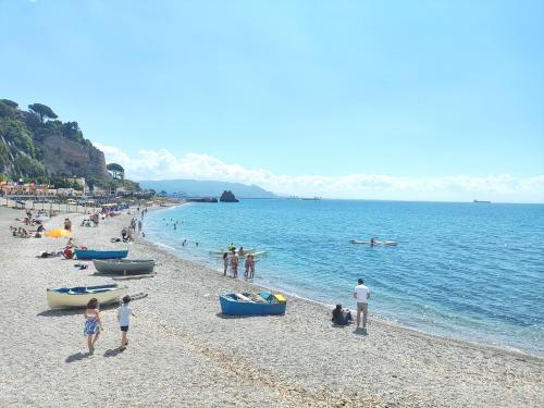 a group of people on a beach near the water at Casa Dama in Vietri sul Mare