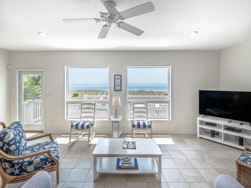 a living room with a couch and a tv at Over The Moon in Kure Beach