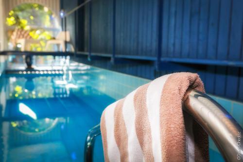 a towel sitting on a chair in a swimming pool at La Cour Berbisey - Teritoria in Dijon