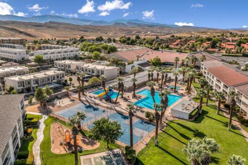 an aerial view of a resort with a pool and palm trees at Modern Resort Condo - Pools, Courts & Scenic Views in St. George