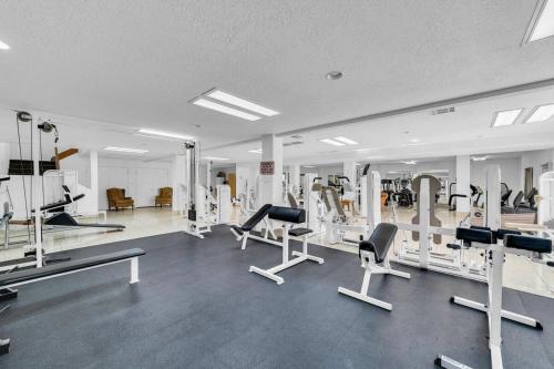 a gym with several treadmills and machines in it at Modern Resort Condo - Pools, Courts & Scenic Views in St. George