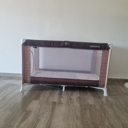 a tv stand in a room with a wooden floor at Sea View apartment in Gythio