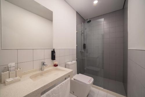 a bathroom with a toilet and a sink and a shower at Duo Hotel by Futuro in Bishkek