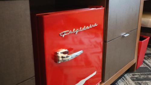 an old red refrigerator with a toy car on the door at The Alder in Monticello