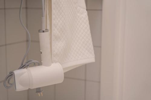 a roll of toilet paper on a holder in a bathroom at Duo Hotel by Futuro in Bishkek