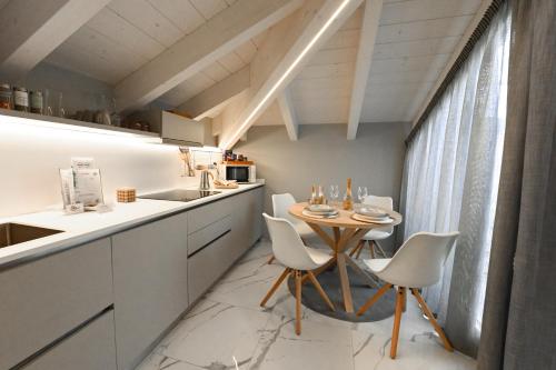 a kitchen with a table and chairs in a room at Camere Amely in Sanremo
