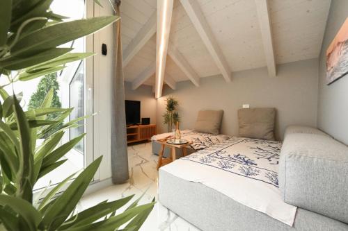 a bedroom with a bed and a potted plant at Camere Amely in Sanremo