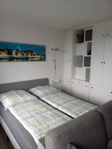 a bedroom with a bed with a picture on the wall at Ferienwohnung mit Ostseeblick & Strandlage in Sierksdorf