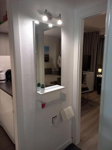 a bathroom with a mirror and a sink at Ferienwohnung mit Ostseeblick & Strandlage in Sierksdorf