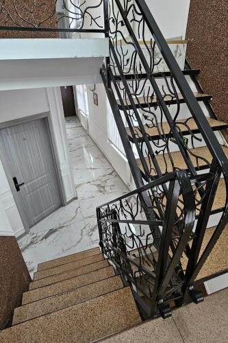 a staircase with a black and white stair railing at Flamingo Hotel in Piteşti