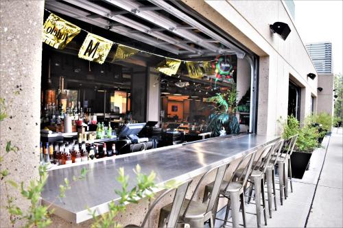 a bar with chairs and a bar with a restaurant at The Alder in Monticello