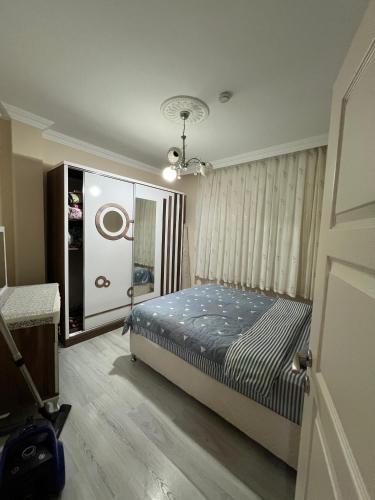 a bedroom with a bed in a room with a window at Yavuz Luxury Apartments in Macka