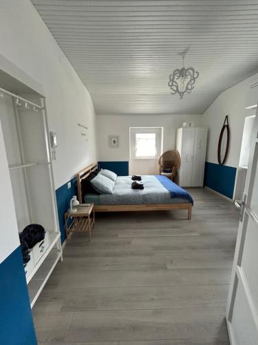 a bedroom with a bed and blue and white walls at Acchiappasogni Holiday House in Malgrate