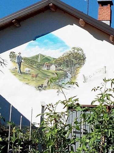 a mural of a man on the side of a building at Il Ciliegio di Lurisia in Lurisia