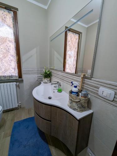 a bathroom with a sink and a mirror at Photo House Collodi La Villetta in Collodi