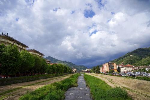 an empty road in a city under a cloudy sky at Photo House Collodi La Villetta in Collodi