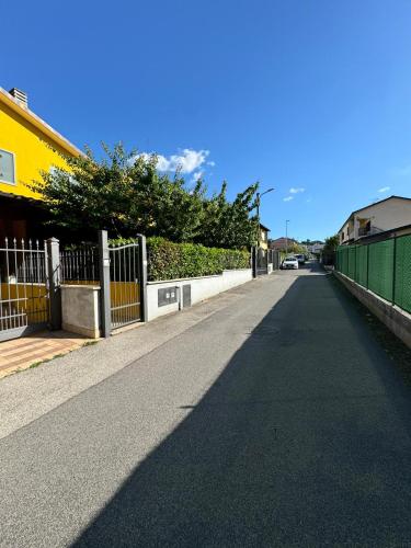 an empty street with a fence on the side of the road at La casa di Glenda bis - alloggio zona ospedale in Terni