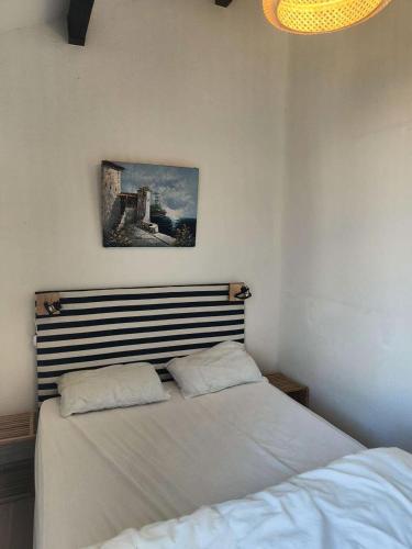 un lit dans une chambre avec un tableau sur le mur dans l'établissement Résidence Grenada - Appartement 5 couchages LE BARCARES vue splendide sur lac marin MAE-1794, au Barcarès