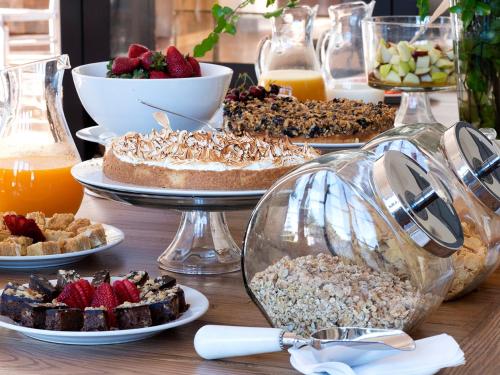 a table topped with desserts and other food at NOI Blend Colchagua in Santa Cruz