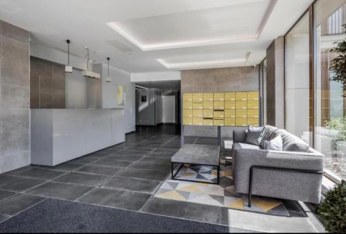 a living room with a couch and a table at Maplewood properties - One bedroom luxurious apartment - Elm in St. Albans