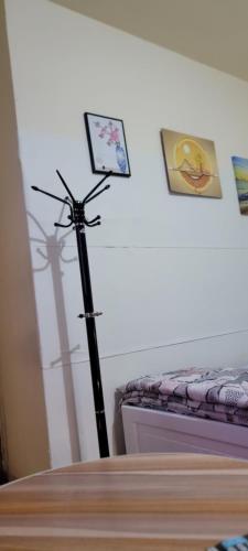 a wand in a room next to a bed at MAMA DELiGHT HOME in Abu Dhabi