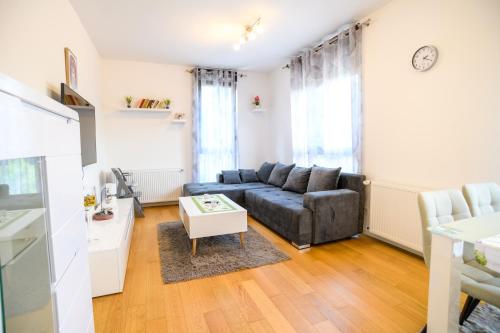 a living room with a couch and a table at Apartman ZABOK CENTAR in Zabok