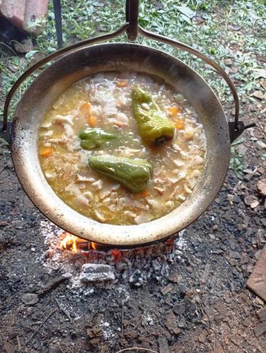 a pot of soup on top of a fire at Seosko domaćinstvo Selenić in Rogačica